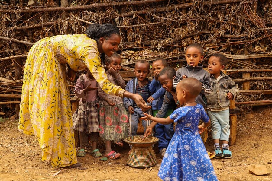 Tadel Gebeyehu, served kids with roasted wheat &nbsp;after receiving food assistance in Beyeda, Amhara region of Ethiopia.