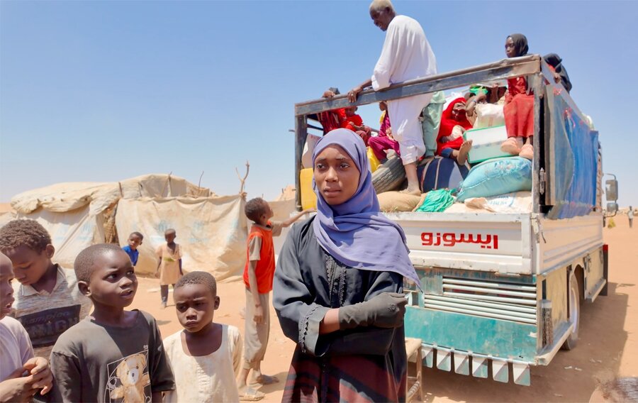After fleeing to eastern Sudan, Dalia Abdellatif Babiker (C) has opted to board this truck and make the 500 km journey home - even though she's uncertain about what she'll face. WFP/Abubakar Garelnabei