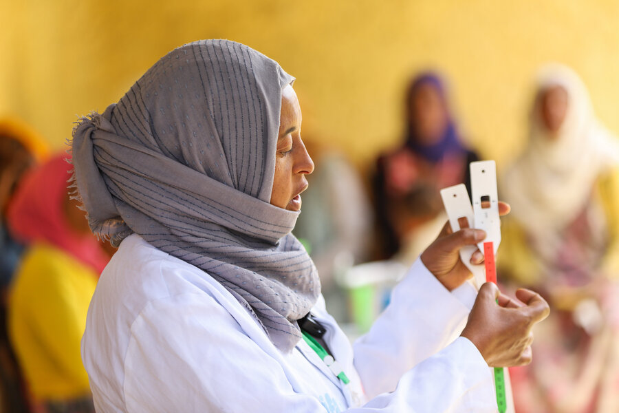 Health worker Aisha Hassen shows women in Ethiopia's Amhara region how to use a special MUAC tape to detect malnutrition in their children. Photo: WFP/Michael Tewelde