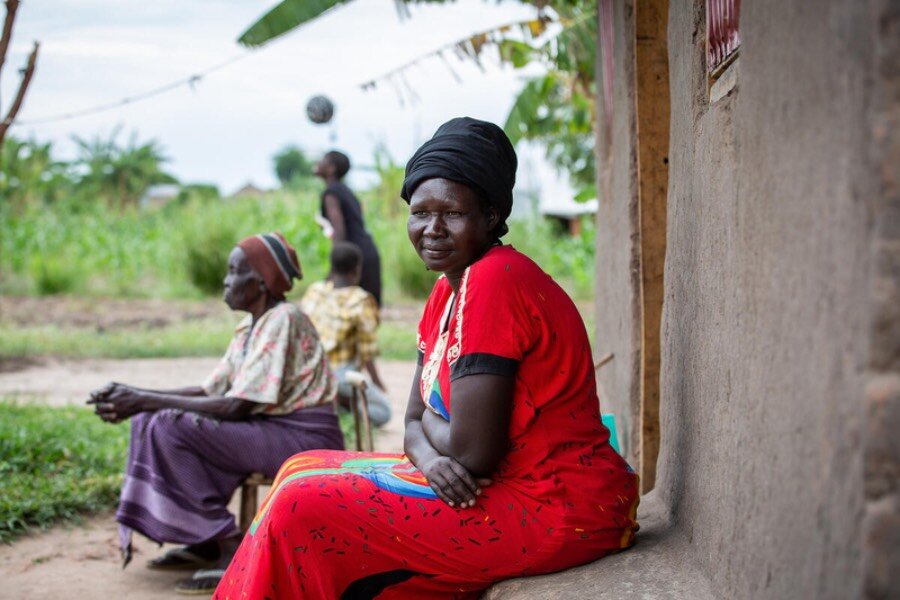 Jemima, sitting on a stoop, counts among the many refugees in Uganda cut from WFP food assistance, for lack of enough funding for our refugee operations. Photo: WFP/Daisy Masembe