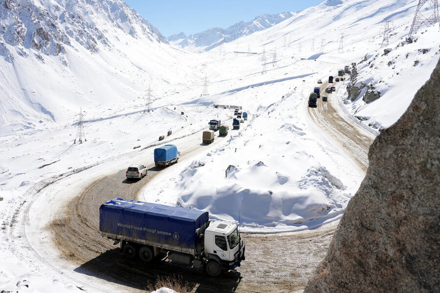 A convoy of WFP trucks winds its way up a snow-covered mountan route