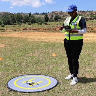 A member of the Lesotho Vulnerability Assessment Committee flying a drone during WFP’s drone training.