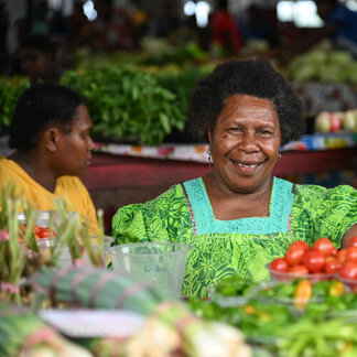 a woman selling vegetabsles