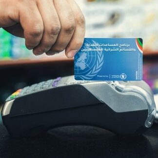 WFP offers its cash-based transfer platform to national institutes and humanitarian institutes to ensure efficient reach to targeted population. Photo: WFP/Mostafa Ghroz