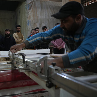 A man is working in the Vocational Training Center in Nineveh where 500 participants joined vocational and entrepreneurship training. 
