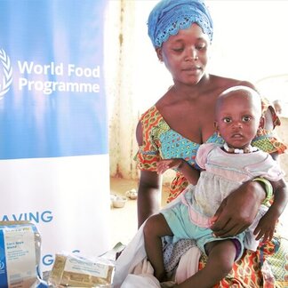 Women and her child receiving nutrition assistance at WFP centre. Photo: WFP/Mamadou Jallow