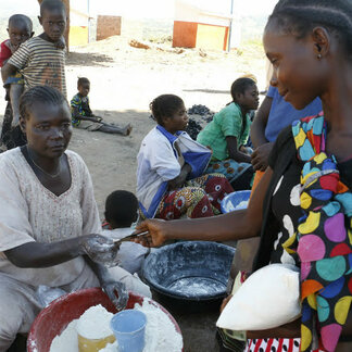 Woman buying food with WFP cash assistance in DR Congo